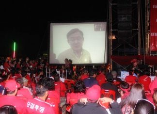 UDD enthusiasts listen to a call in from self-exiled leader Thaksin Shinawatra.